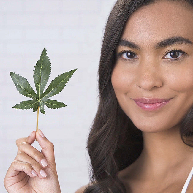 Girl holding hemp leaf
